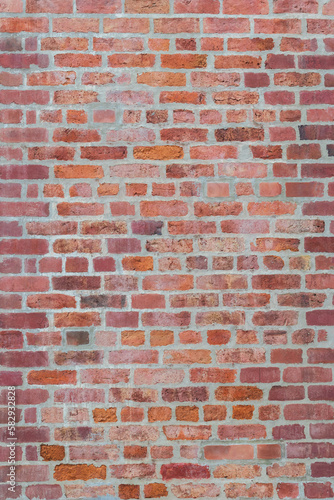 Vertical background of vintage brown bricks block wall with soft lighting. Grunge wallpaper for decorative or design. Restricted area or obstruction concept.