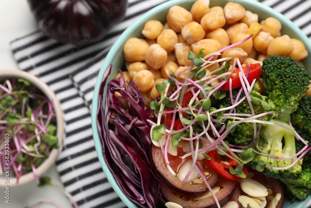 Delicious vegan bowl with broccoli, red cabbage and chickpeas on white table, flat lay Delicious vegan bowl with broccoli, red cabbage and chickpeas on white table, flat lay