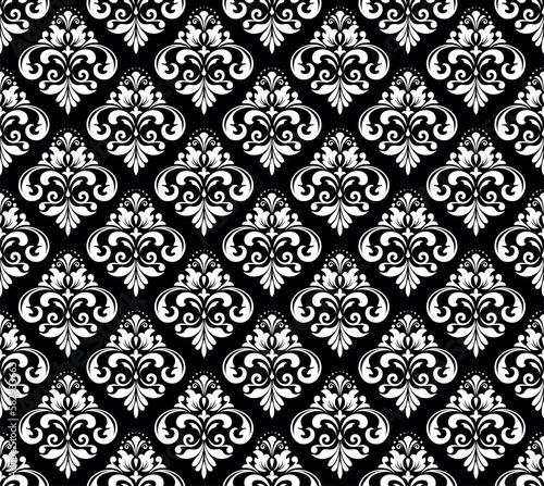 Wallpaper in the style of Baroque. Seamless vector background. White and black floral ornament. Graphic pattern for fabric, wallpaper, packaging. Ornate Damask flower ornament