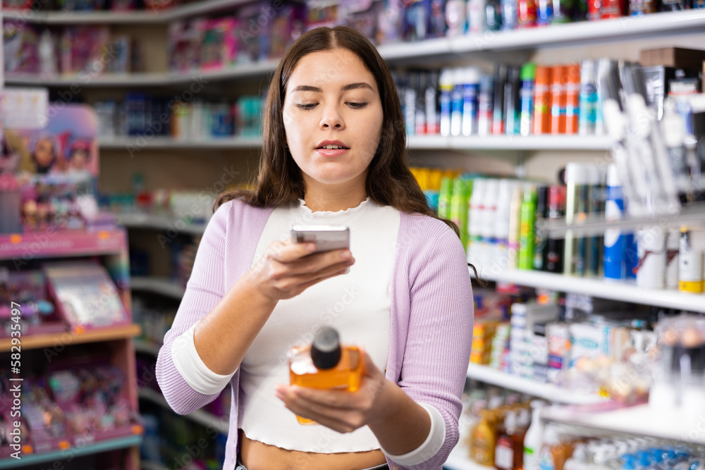 Female shopper scanning a QR code using a mobile phone in a cosmetics store