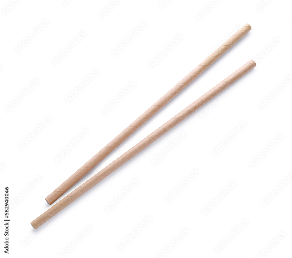 Beige paper cocktail straws on white background, top view