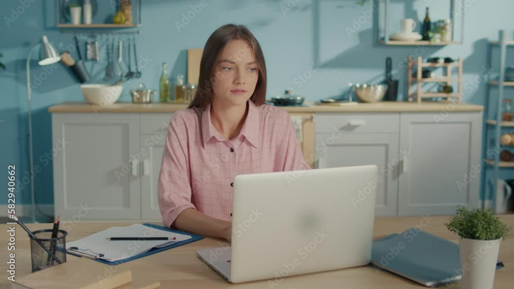 Excited Young Woman Winner Looks at Laptop Celebrates Online Success Sits in Kitchen at Home. Euphoric Lady Gets Distance Job Opportunity, Reads Good News in Email, Rejoices Victory, Feels Motivated. Excited Young Woman Winner Looks at Laptop Celebrates Online Success Sits in Kitchen at Home. Euphoric Lady Gets Distance Job Opportunity, Reads Good News in Email, Rejoices Victory, Feels Motivated.