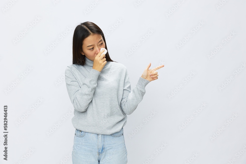 Asian woman holding hand with handkerchief and coughing up flu and cold, stuffy nose viral disease asthma and allergies covid, white background Asian woman holding hand with handkerchief and coughing up flu and cold, stuffy nose viral disease asthma and allergies covid, white background