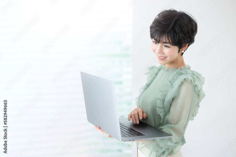 Image of a cute web designer-like woman holding a computer. Image of a cute web designer-like woman holding a computer.