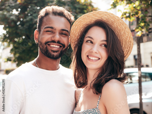 Smiling beautiful woman and her handsome boyfriend. Woman in casual summer clothes. Happy cheerful family. Female having fun. Sexy couple posing in the street at sunny day. In hat