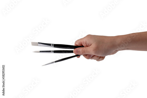Hand using a little paintbrush isolated on a transparent background