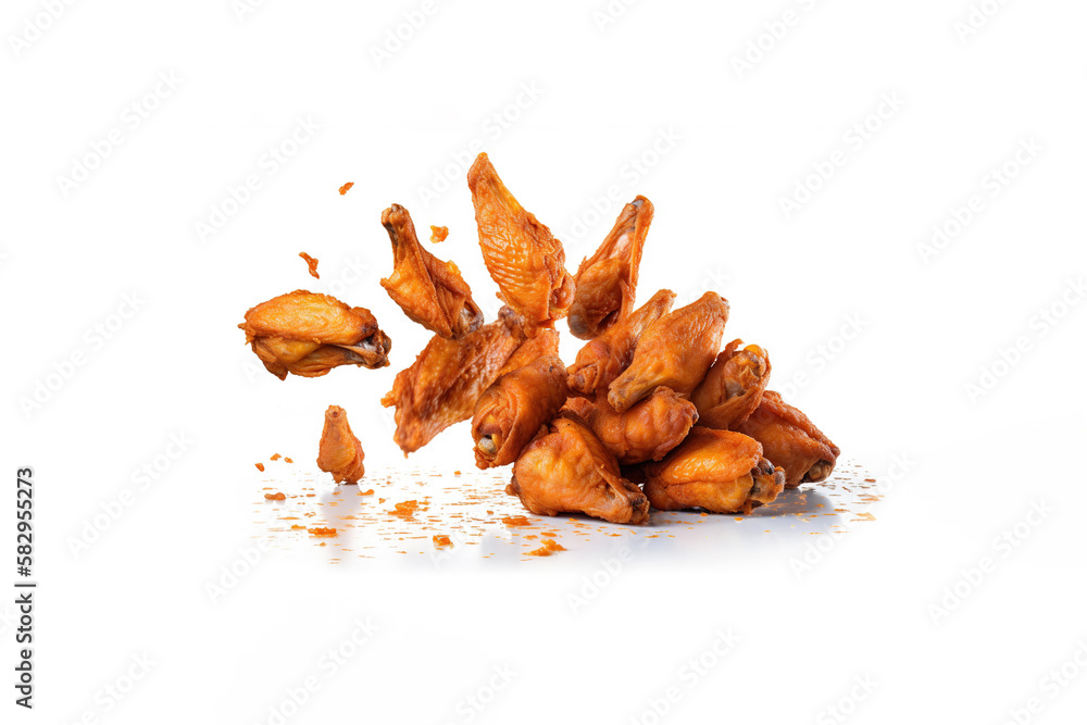 Tasty falling fried spicy chicken wings isolated on white background. Created with Generative AI Technology