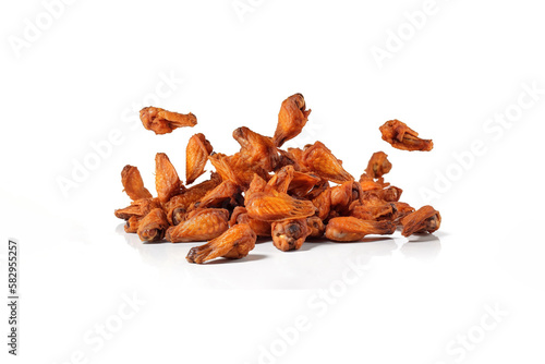Tasty falling fried spicy chicken wings isolated on white background. Created with Generative AI Technology