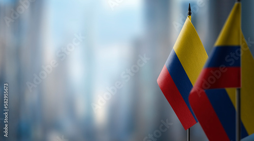 Small flags of the Colombia on an abstract blurry background photo