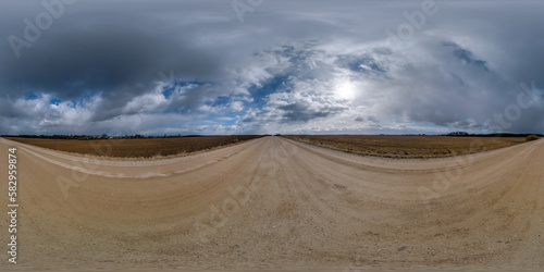 spherical 360 hdri panorama on gravel road with clouds on overcast sky in equirectangular seamless projection  use as sky replacement in drone panoramas  game development as sky dome or VR content