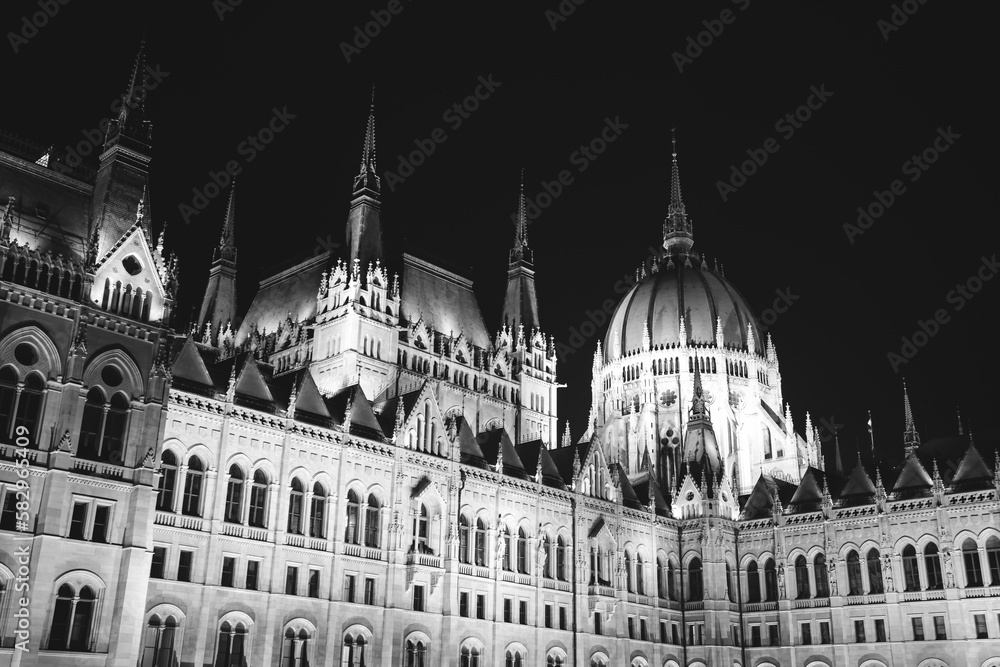 Obraz premium Budapest parliament illuminated at night and Danube river, Hungary