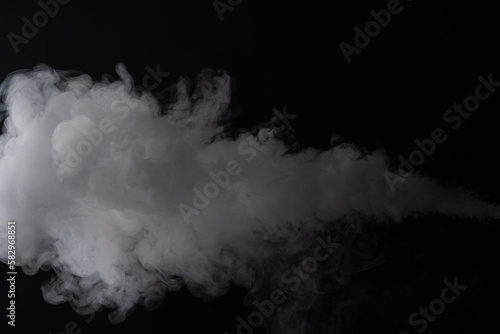 Cloud of white smoke on a black background closeup