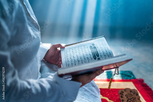 Muslim person with Quran  Ramadan Month praying concept image