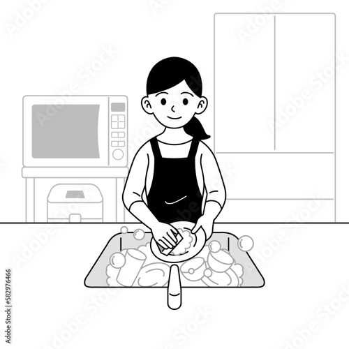 食器を洗う主婦　モノクロ