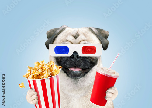 Funny happy pug dog with 3D glasses eating popcorn and drinking Coke in a cinema, watching a movie premiere. Recreation and television, a creative idea. Film screening, concept