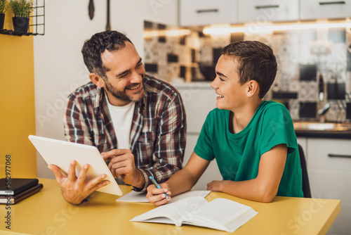 Принти на полотні Father is helping his son with learning