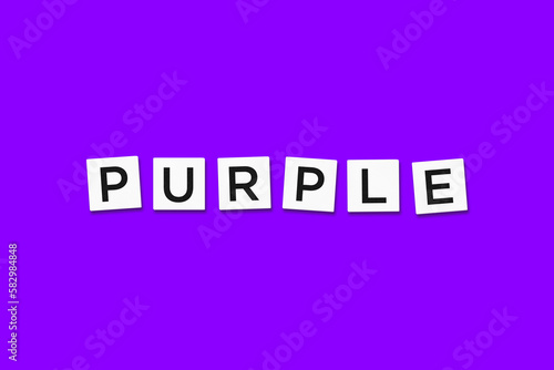 The word PURPLE, spelt with letter Scrabble tiles on a purple background