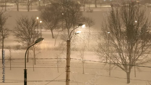 Snow storm in winter city, falling snow. Winter blizzard 
