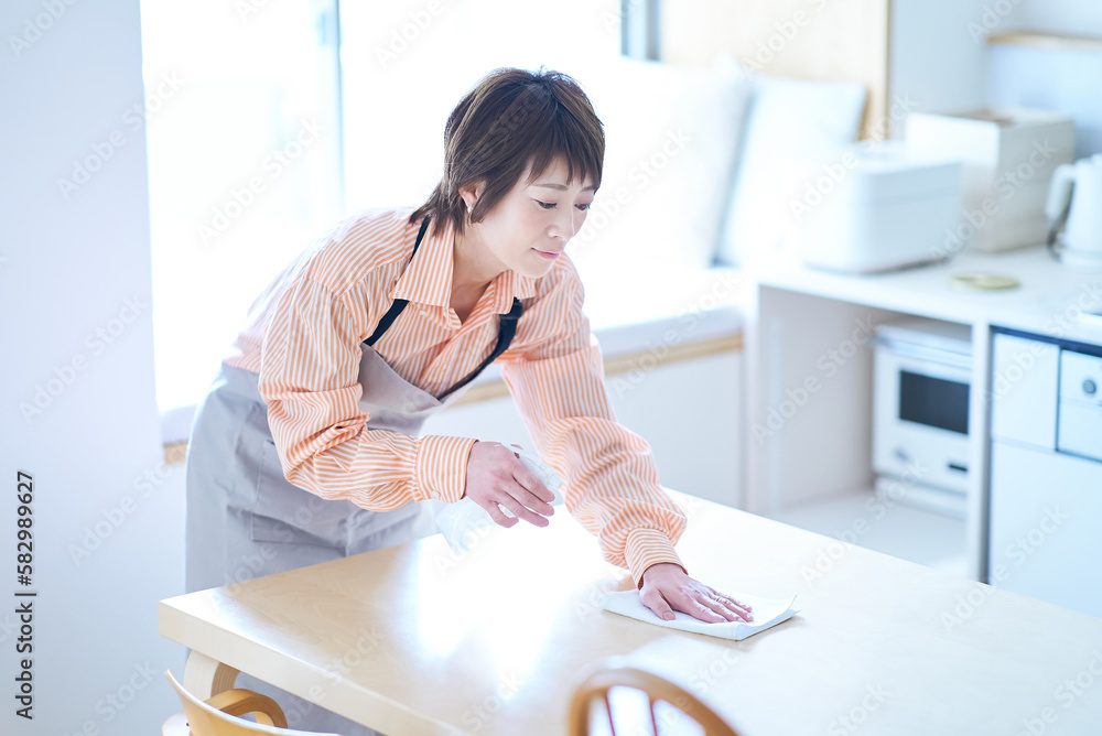 ダイニングテーブルを拭く女性 Stock Photo | Adobe Stock