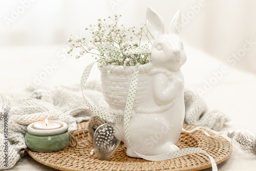 Easter composition with a ceramic hare and gypsophila flowers.