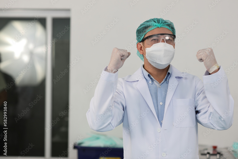 Worker in personal protective equipment or PPE inspection quality raising hands with exciting emotion in mask and medical face mask production line factory, manufacturing industry and factory concept. Worker in personal protective equipment or PPE inspection quality raising hands with exciting emotion in mask and medical face mask production line factory, manufacturing industry and factory concept.