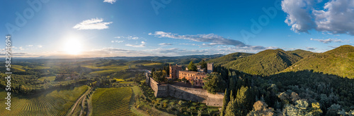 Italy, Tuscany, San Regolo, Aerial view of Castello di Brolio and surrounding landscape at summer sunset