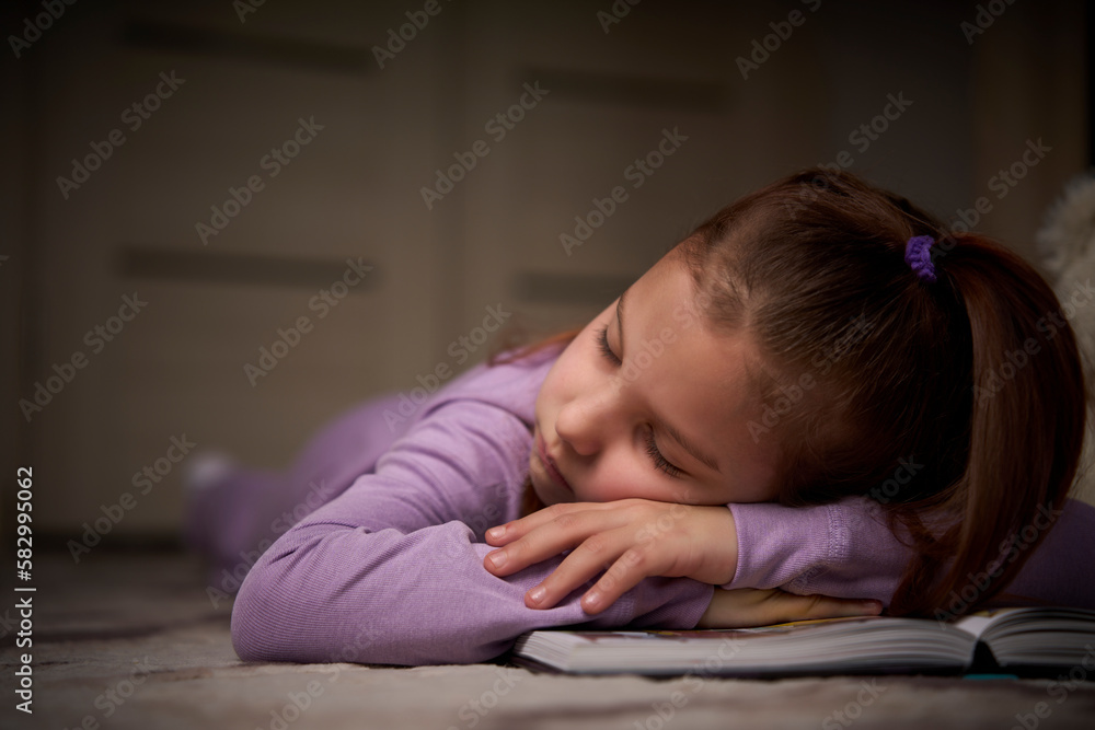 Child girl sleeping with book and bear toy Child girl sleeping with book and bear toy