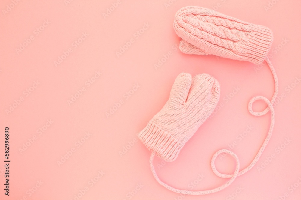 Close-up pink mittens and shaped of string on pink background. Lifestyle and warm feelings concept. Valentine day. Monocolor romantic pattern. Winter theme. Flat lay composition. Top view. Copy space Close-up pink mittens and shaped of string on pink background. Lifestyle and warm feelings concept. Valentine day. Monocolor romantic pattern. Winter theme. Flat lay composition. Top view. Copy space