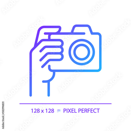 Hand with camera pixel perfect gradient linear vector icon. Person taking shot with analog equipment. Photographer tool. Thin line color symbol. Modern style pictogram. Vector isolated outline drawing