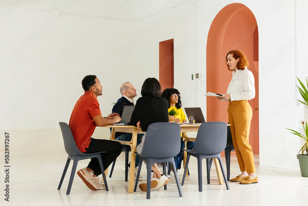 Businesswoman explaining strategy in meeting at office Businesswoman explaining strategy in meeting at office