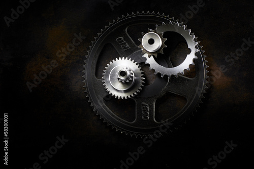 Metal gears lying on dark surface photo