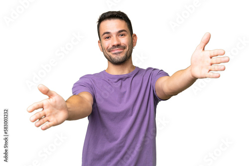 Young handsome caucasian man over isolated background presenting and inviting to come with hand