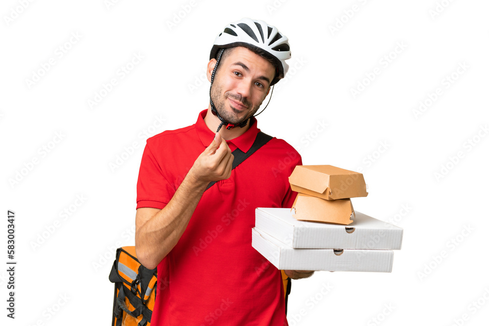 Young handsome caucasian man with thermal backpack and holding takeaway food over isolated background making money gesture Young handsome caucasian man with thermal backpack and holding takeaway food over isolated background making money gesture