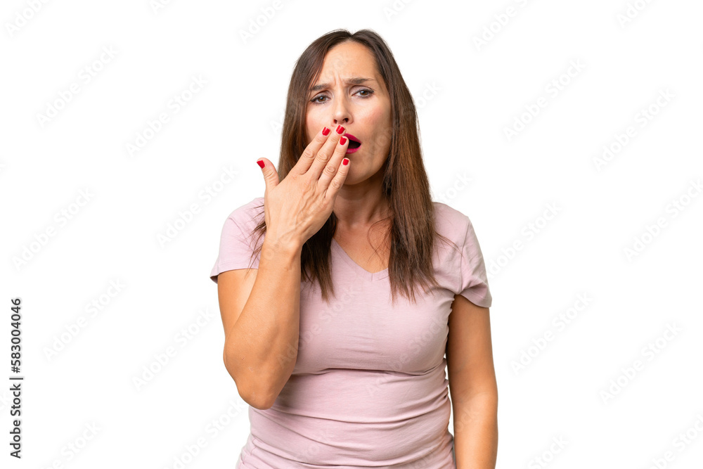 Middle-aged caucasian woman over isolated background yawning and covering wide open mouth with hand Middle-aged caucasian woman over isolated background yawning and covering wide open mouth with hand