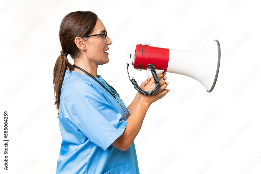 Middle-aged nurse woman over isolated background shouting through a megaphone Middle-aged nurse woman over isolated background shouting through a megaphone