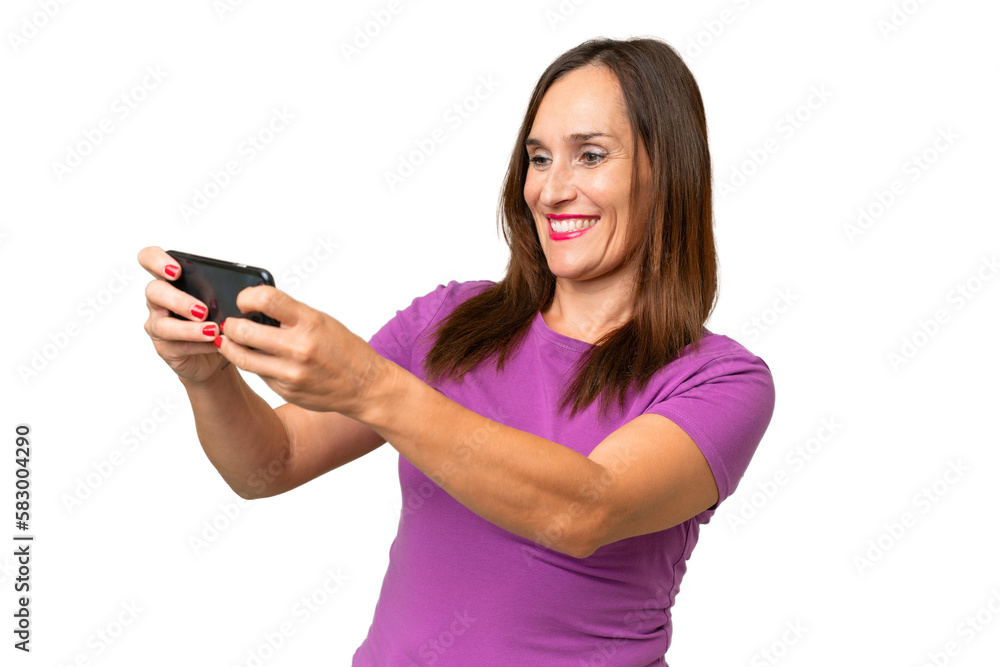 Middle-aged caucasian woman over isolated background playing with the mobile phone Middle-aged caucasian woman over isolated background playing with the mobile phone