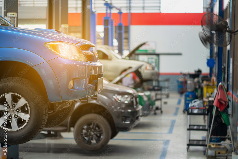 Image of a car oil change service center with modern tools and professional maintenance technicians Image of a car oil change service center with modern tools and professional maintenance technicians