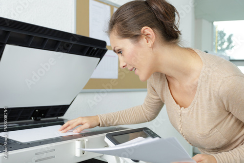 female worker using photocopy machine photo