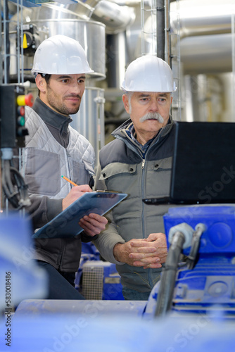 engineers of a facility monitoring a progress report