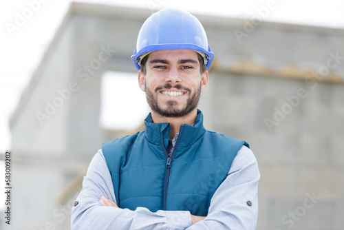 a happy builder smiling at the camera