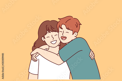 Positive little boy and girl hugging and laughing enjoying spending time together or summer vacation. Concept of happy childhood and friendship between classmates or little brother and sister 