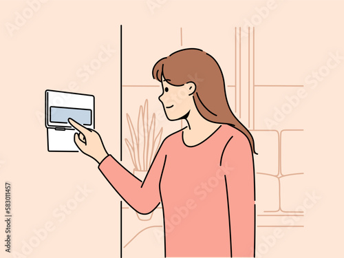 Smiling woman using smart home system on apartment wall. Female renter turn on alarm or security on panel in house. Indoor technology. Vector illustration. 