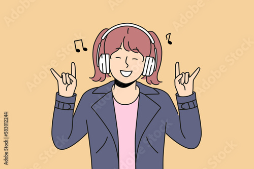Smiling girl child listen to music in wireless headphones make rock n roll gesture. Excited kid in earphones have fun enjoying rock songs. Vector illustration. 