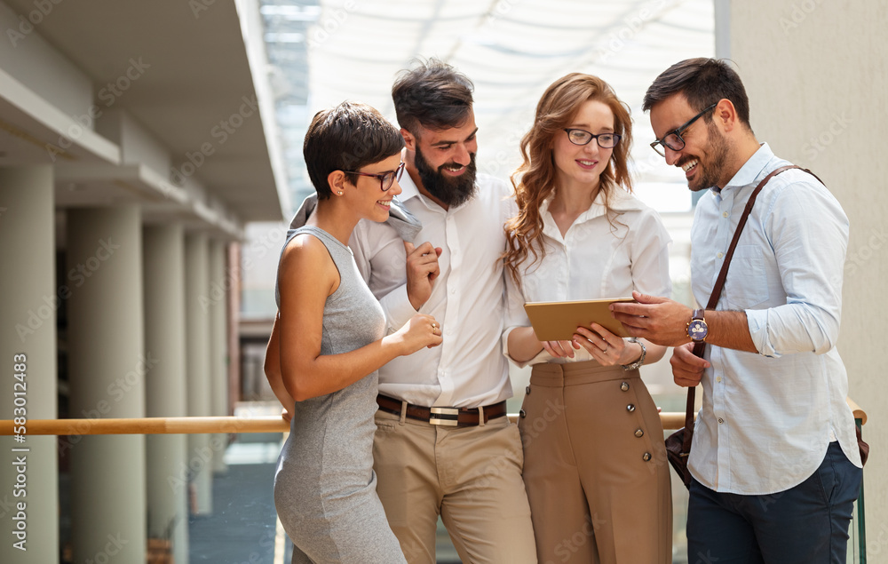 Happy business people, colleagues in modern office working together and using tablet Happy business people, colleagues in modern office working together and using tablet