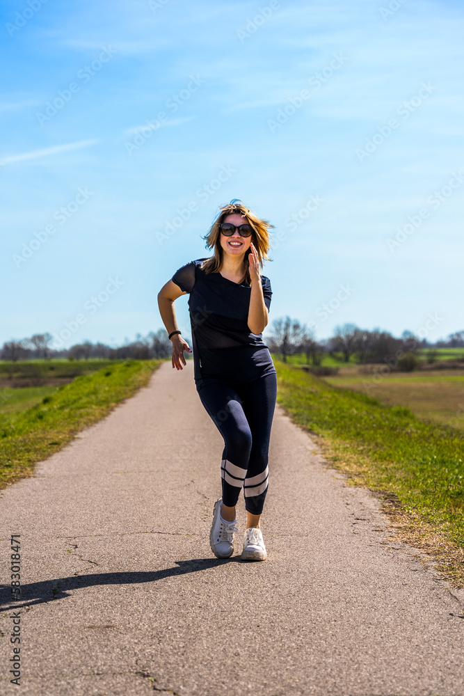 beautiful sporty woman having fun dancing in a country road beautiful sporty woman having fun dancing in a country road