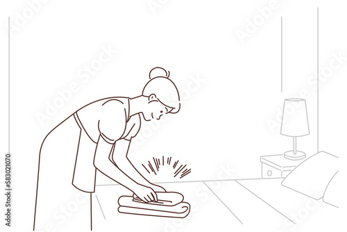 Housekeeper working in hotel room 