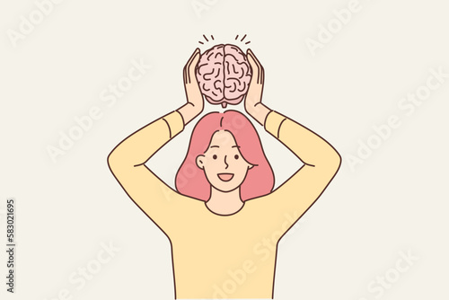 Smiling woman hold brain model 
