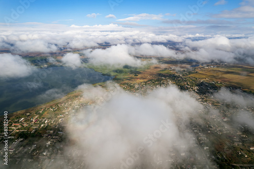 Atmosphere of flying above clouds. Sky thunderclouds  horizon line from an airplane drone. Creative background for design. Dawn  sun over clouds - positive travel concept of meditative joy of future