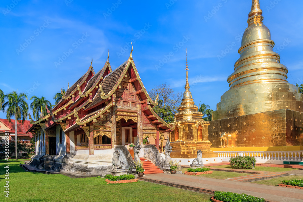 Fototapeta premium Chapel and golden pagoda at Wat Phra Singh Woramahawihan, famous travel destination in Chiang Mai, Thailand