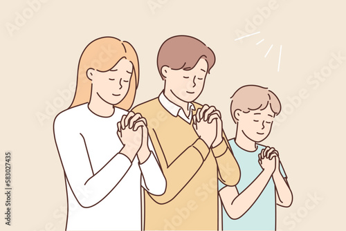 Religious family with child praying 
